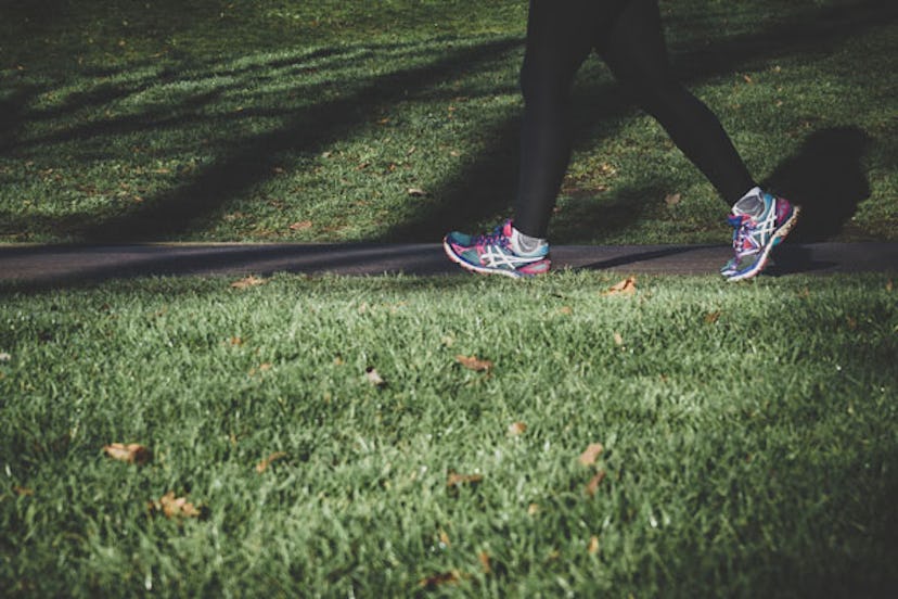 A close-up of a woman's legs while she's running in a park