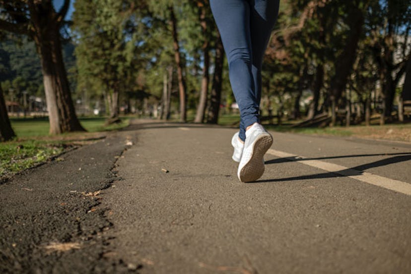 A close-up of a woman's legs while she's running in a park
