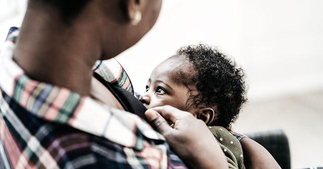 A mom breastfeeding her baby in a public space who needs black lactation spaces to be inclusive
