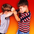 A boy hitting another boy back and the background is deep orange with the Scary Mommy logo