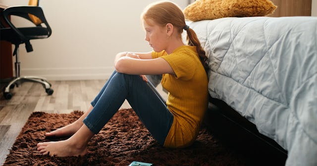 A tween who is upset about her peer being upset with TikTok sitting in her room