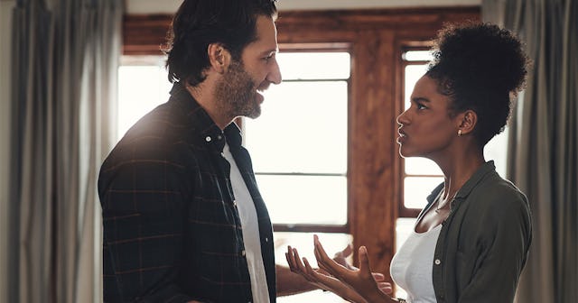 Husband and wife having an argument while tackling a home project standing in their living room