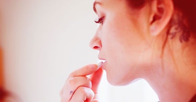 Woman taking a pill without water