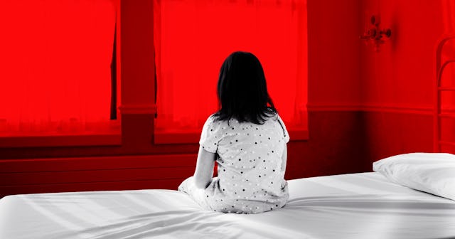 Kid taken away from parents after a misdiagnosis sitting on a bed