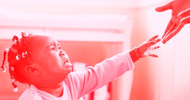 A 2 year-old having a tantrum and reaching out with one hand to someone.