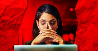 Woman sitting in front of her laptop with her hands crossed and leaned on her face wanting to quit h...