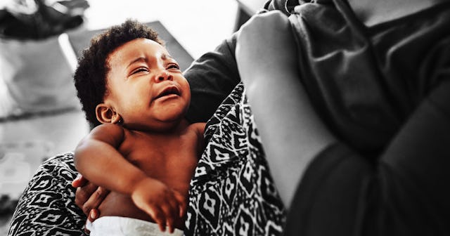 A child crying because of breastfeeding struggles