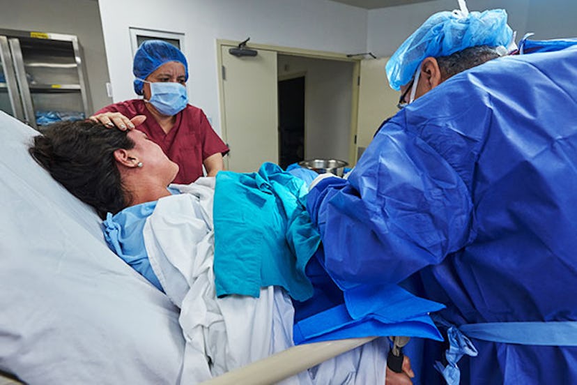Woman in labor surrounded by doctors 