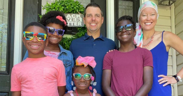 A white dad and an interracial mom with their adopted four black kids