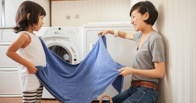 Woman and daughter folding laundry — laundry symbols.