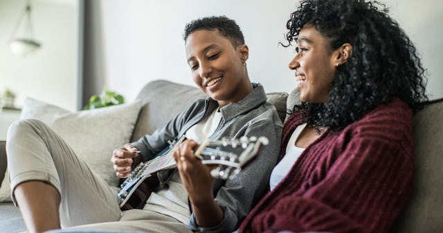 Young couple enjoying the guitar together.