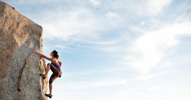 Woman summiting a cliff — bravery quotes.