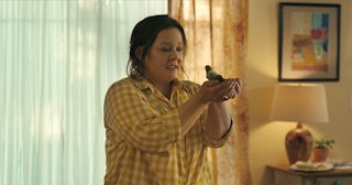 Actress Melissa McCarthy acting as Lily in the movie "The Starling" while holding a bird on her palm...