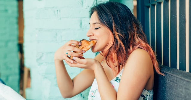 Woman eating croissant — words to describe food.