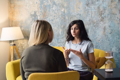  A pair of women engaged in a conversation regarding the utilization of multiple pronouns.