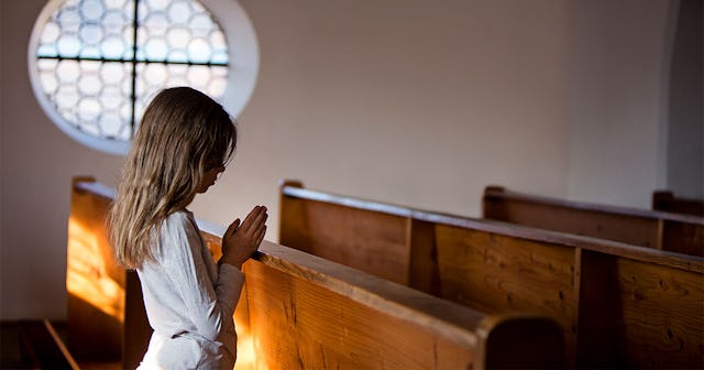 Little girl praying in church