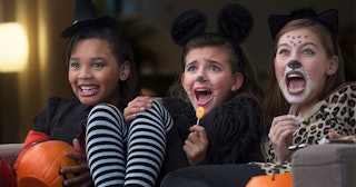 Three Girls In Costumes Watching A Halloween Movie