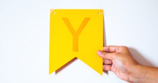 Woman holding a letter Y — words that start with Y.