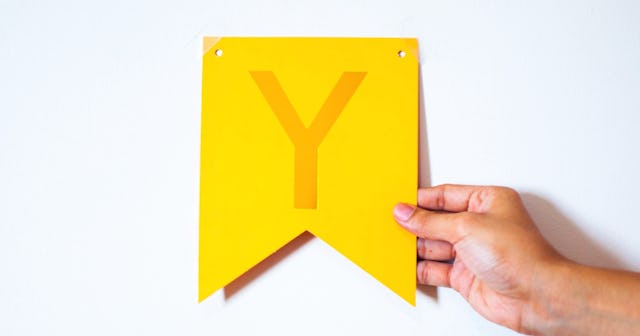 Woman holding a letter Y — words that start with Y.