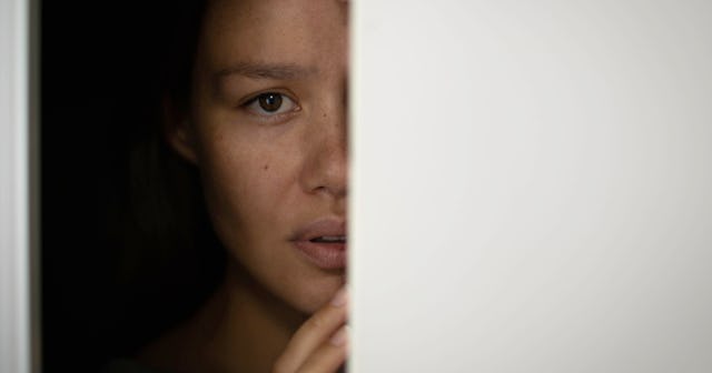 Woman hiding in a dark room — fear quotes.