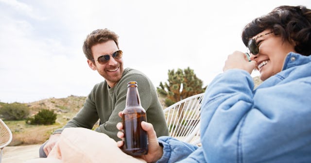 Couple drinking beer and laughing — drinking games for couples.