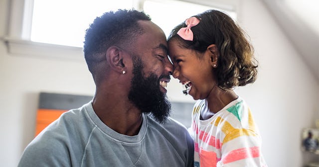 A father who likes to spoil his child smiling while facing his daughter forehead to forehead