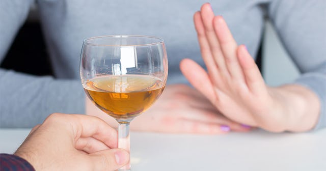 Woman declining a drink due to participation in 'Sober October'