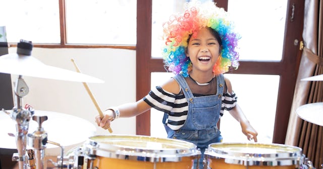 Girl playing drums — drummer jokes and puns.