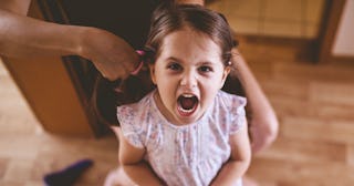 Angry little girl wearing a white and pink dress being rude to a creeper