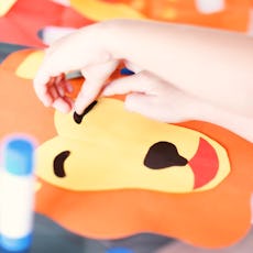 Lion crafts, like this lion paper mask, are a fun activity for kids.