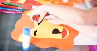 Lion crafts, like this lion paper mask, are a fun activity for kids.