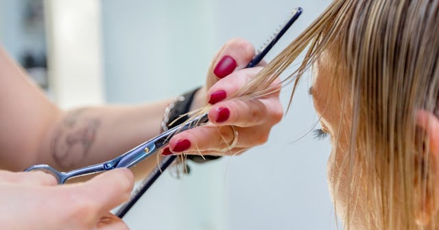 Person getting haircut — what causes split ends