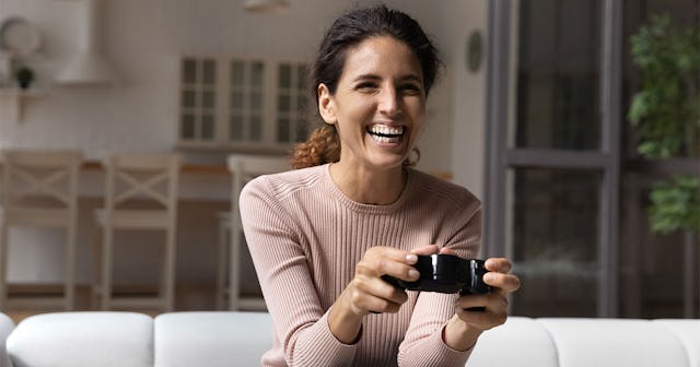 Woman playing video games in her living room