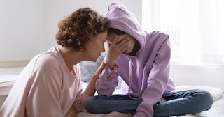 A mother comforting her daughter who's dealing with factors affecting her mental health 