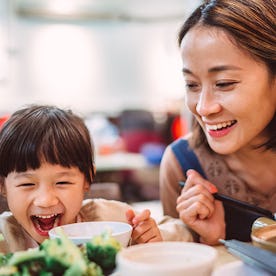 Mom and child enjoying Chinese Food on Thanksgiving