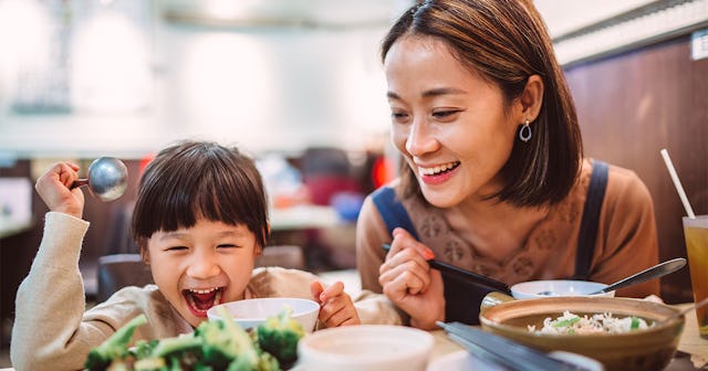Mom and child enjoying Chinese Food on Thanksgiving
