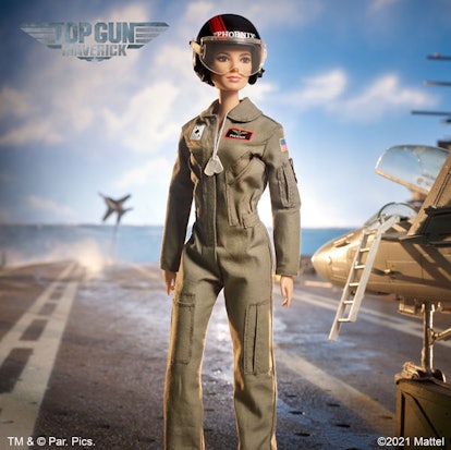 A "Top Gun Maverick" edition of a Barbie doll standing on a carrier in a military suit and helmet.