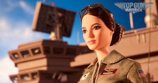 A "Top Gun Maverick" edition of a Barbie doll standing on a carrier in a military jacket.