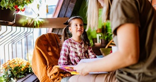 A woman having a sit down with her daughter explaining Thanksgiving