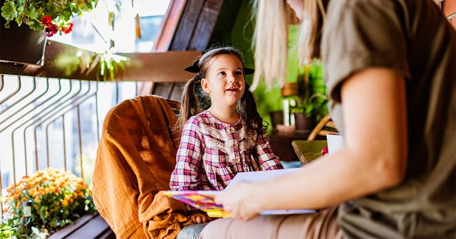 A woman having a sit down with her daughter explaining Thanksgiving