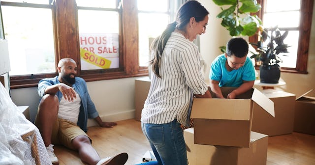 Family opening boxes in new home — real estate jokes