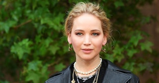 Jennifer Lawrence in a black leather jacket, layered necklaces and earrings