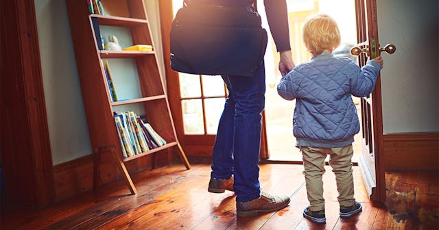 Closeup of a mother leaving a house with her son, as they're holding hands