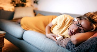 Woman "catching up" sleep on her couch 
