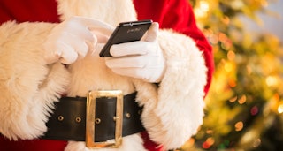 Santa Claus holding his phone 