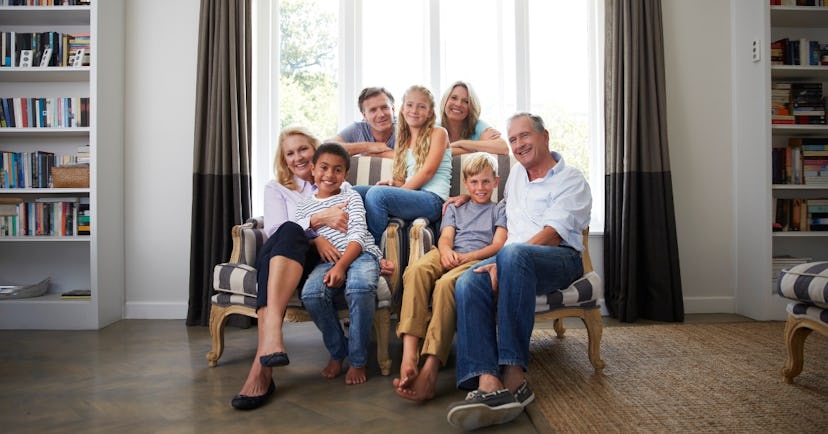 Family sitting in front of window for photos
