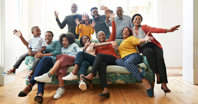Family laughing while posing for pictures — large family photo ideas