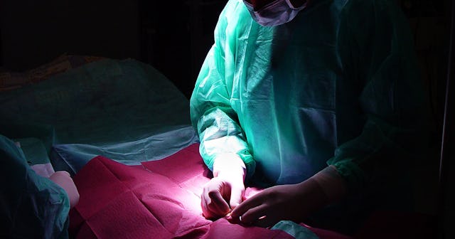 A person having a surgical procedure for removing her breast implants