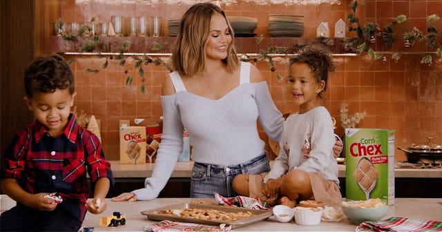 Chrissy Teigen baking cookies with her children in the kitchen