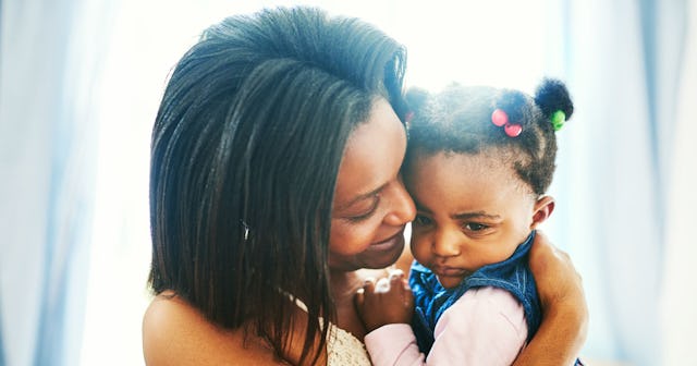 Mother gentle cuddling with her daughter